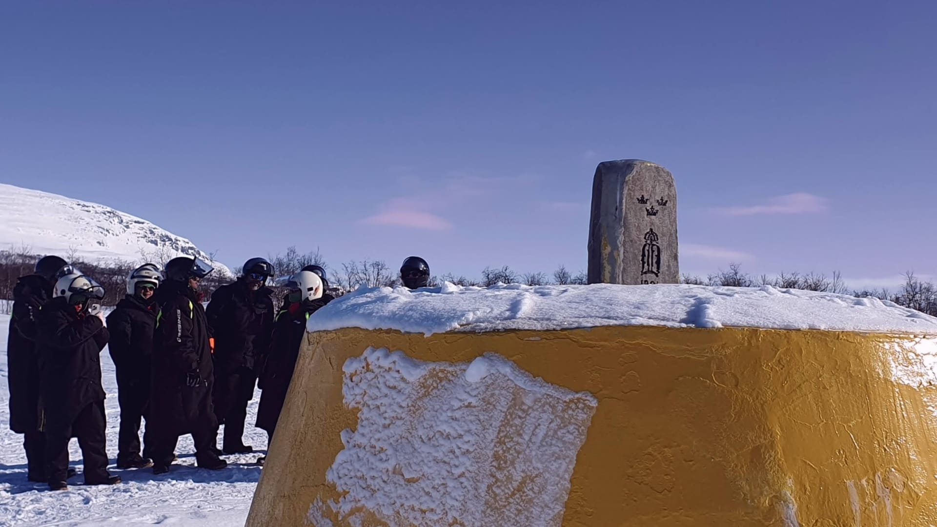 Snowmobile Safari Guests at the Three-Country Cairn