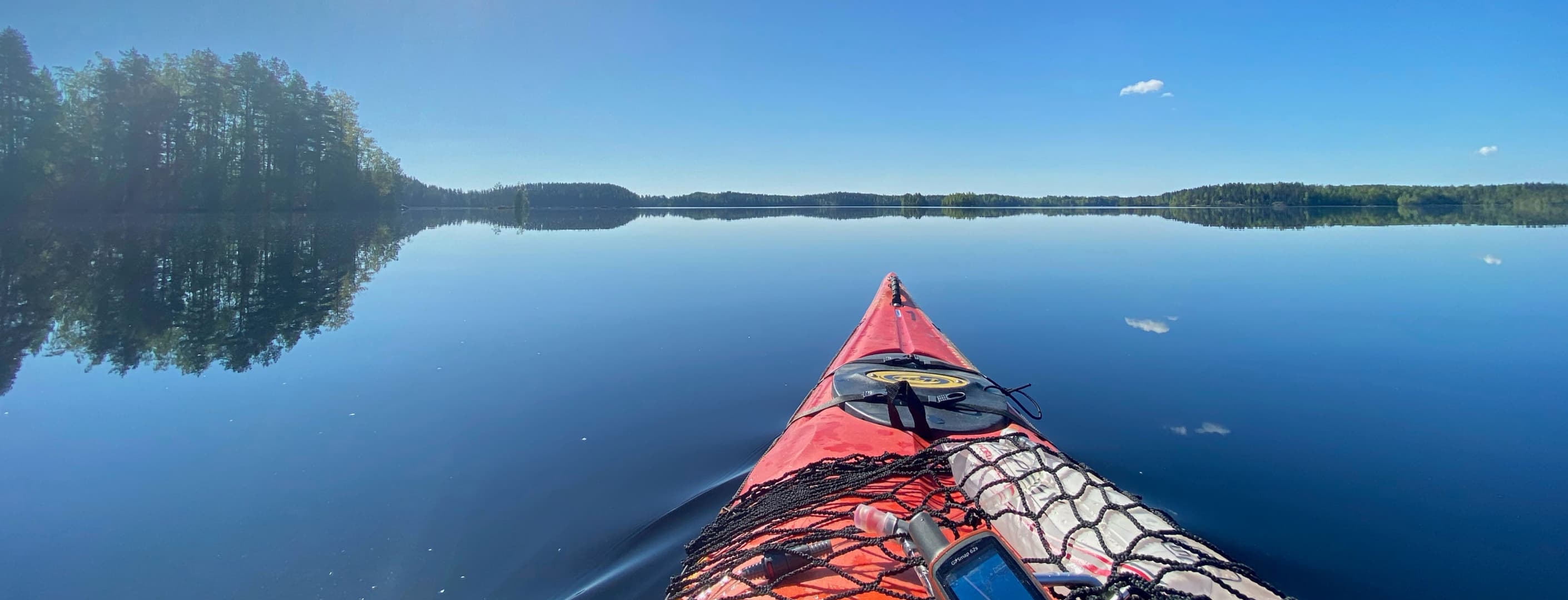 A canoe on a calm lake on a sunny summer day.