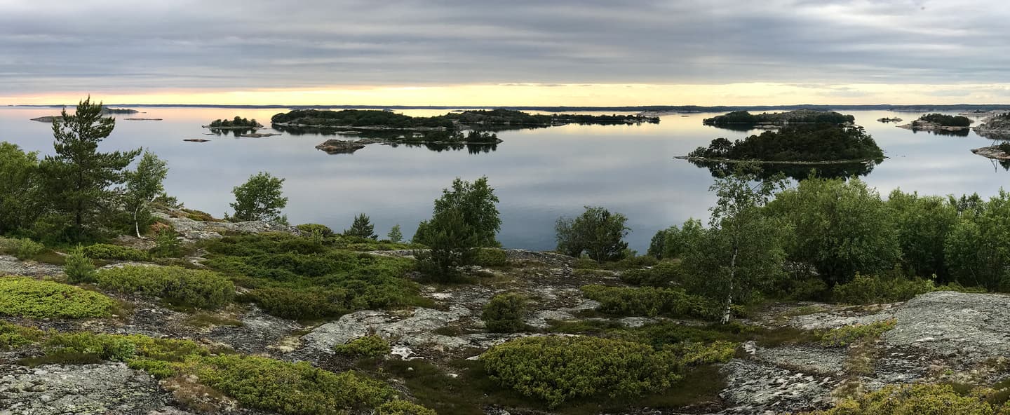 Image: Martti Komulainen A photo of the last moments of the sun on the horizon in summer, taken from the highest point of the island to the west and the calm sea.