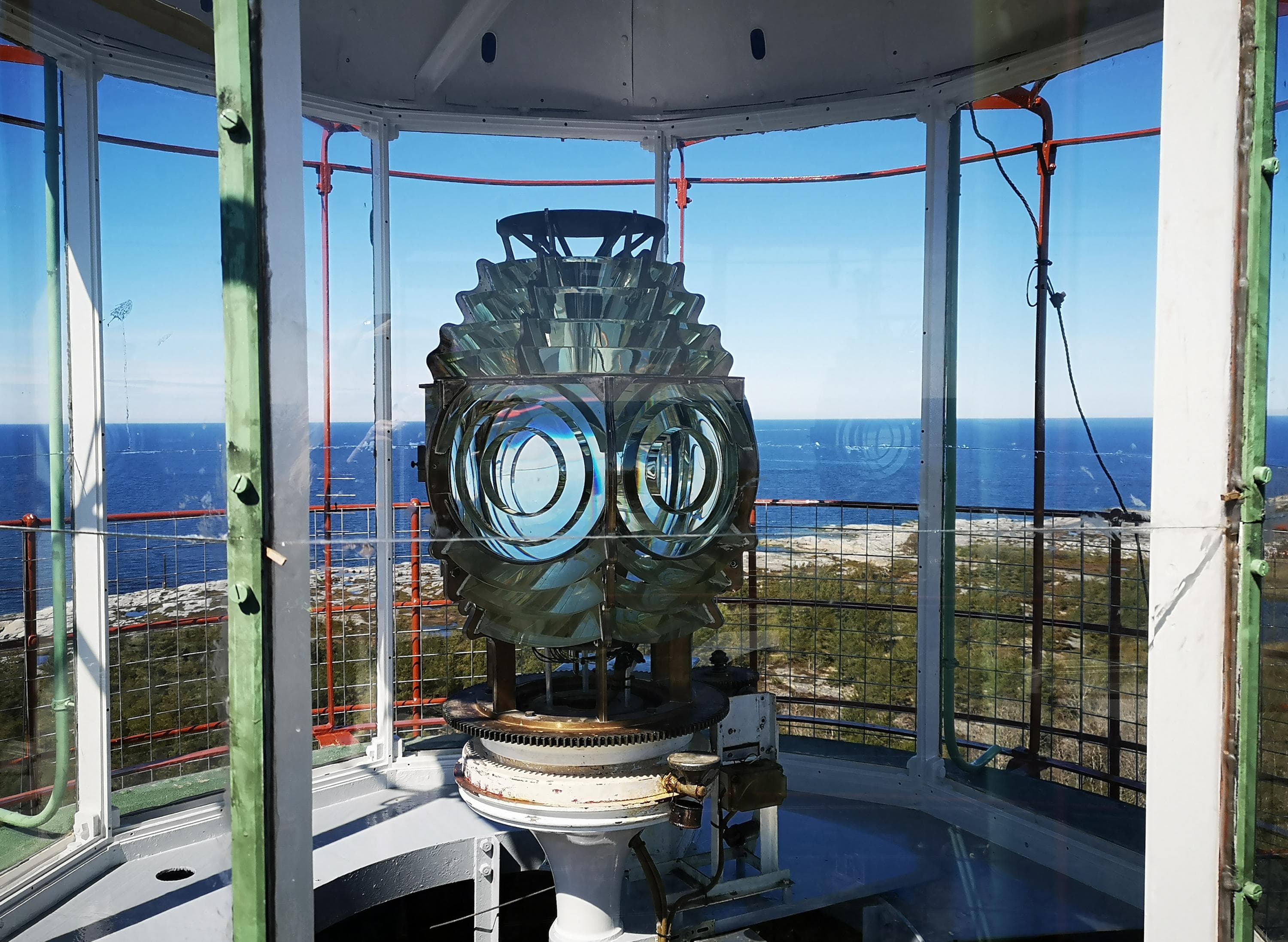 Image: Marjo Kekki An oval ball containing glass and mirrors in the lighthouse tower. The sea is visible through the large windows.