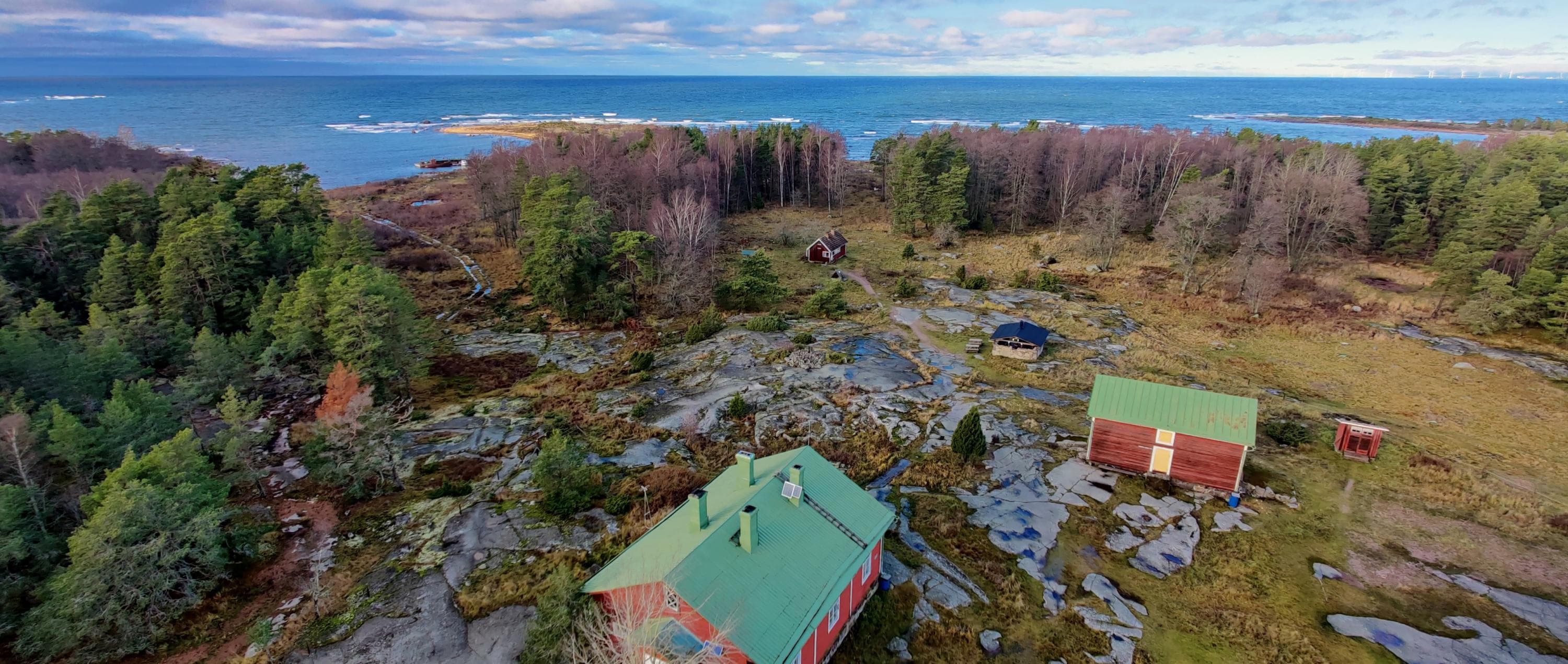 Image: Marjo Kekki A forested and rocky landscape, with the sea visible in the distance.