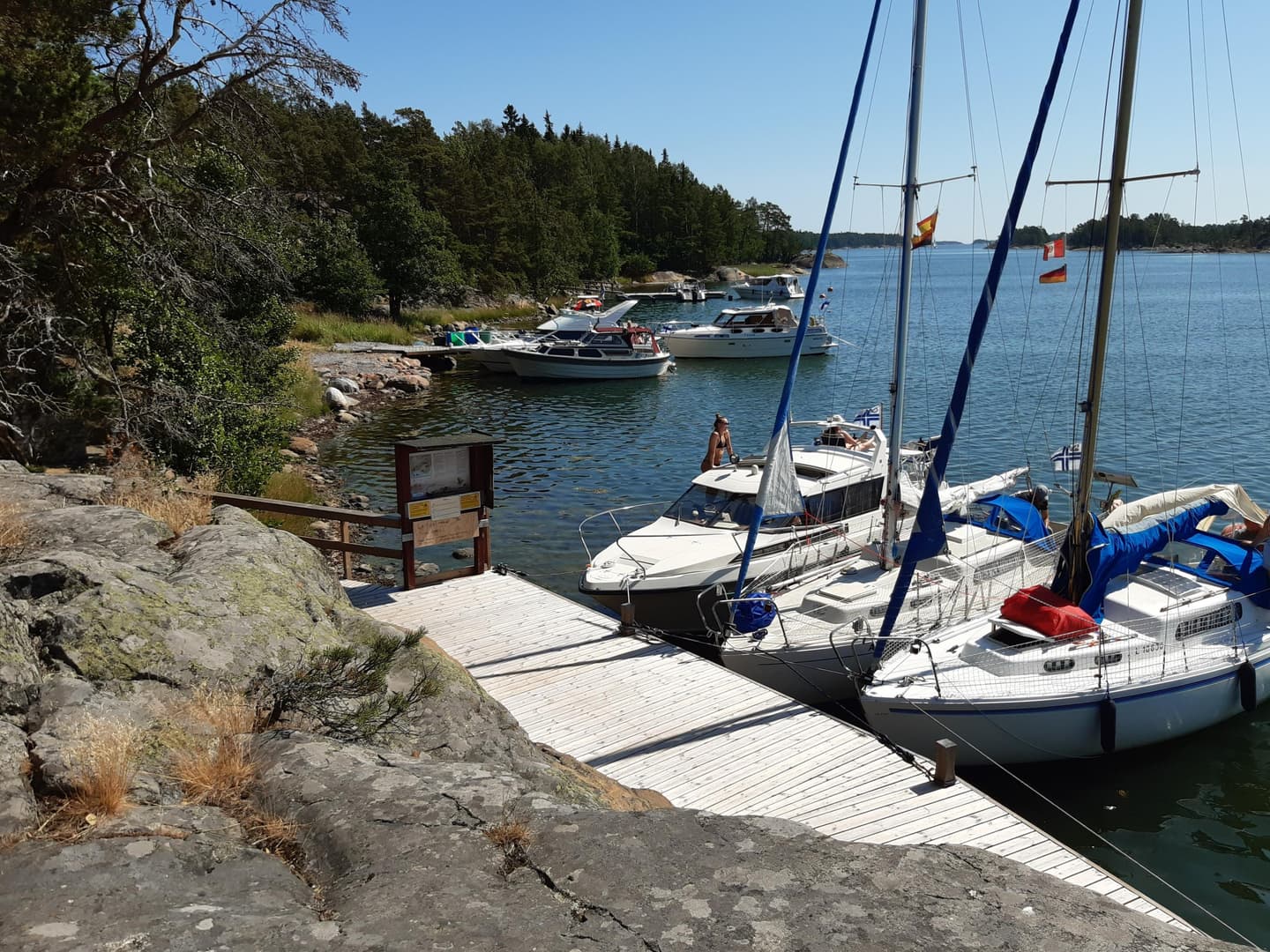 Image: Kirsi Nikkola A pier where three sailboats are anchored.
