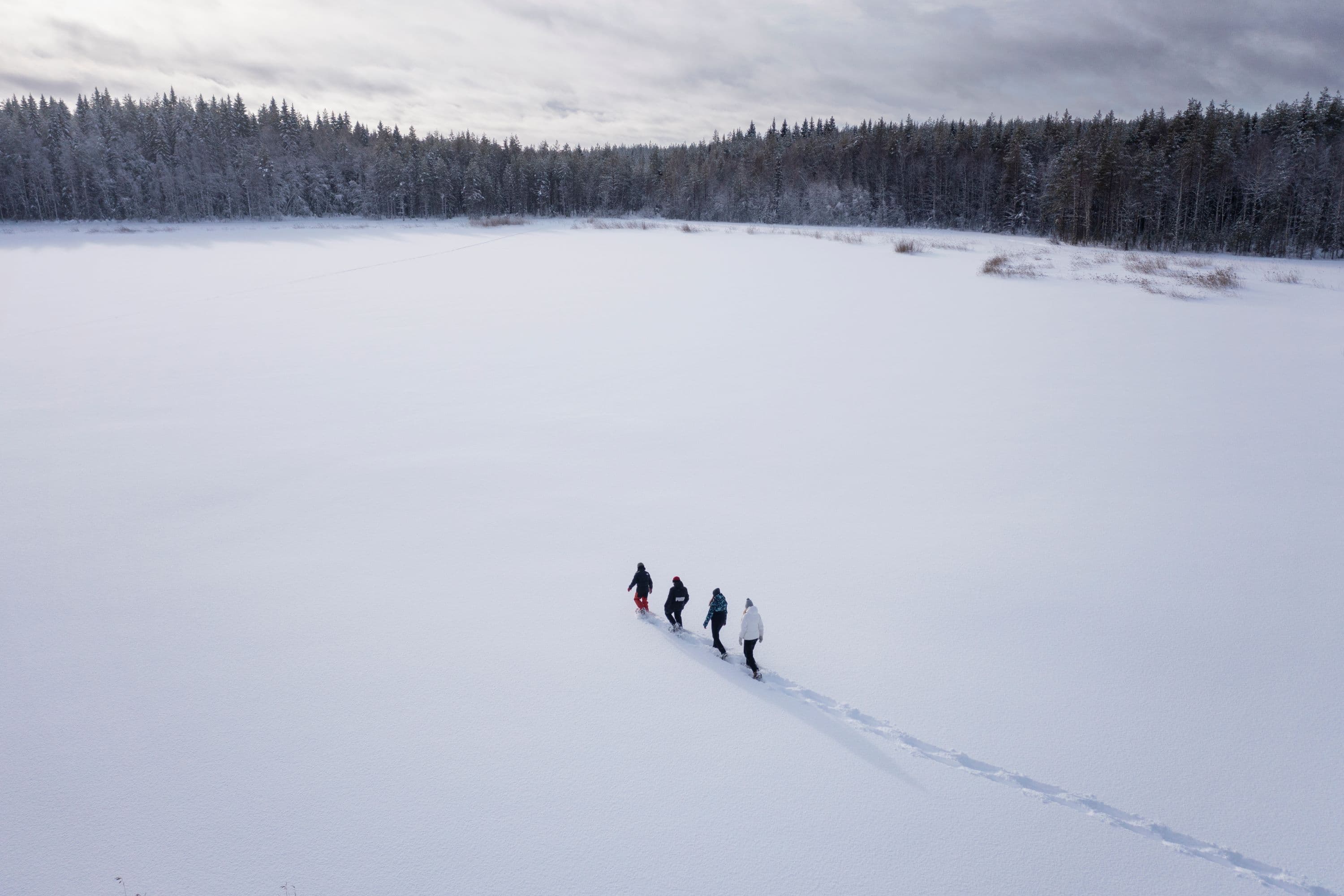 Image: Harri Tarvainen Snowshoers cross an icy lake.