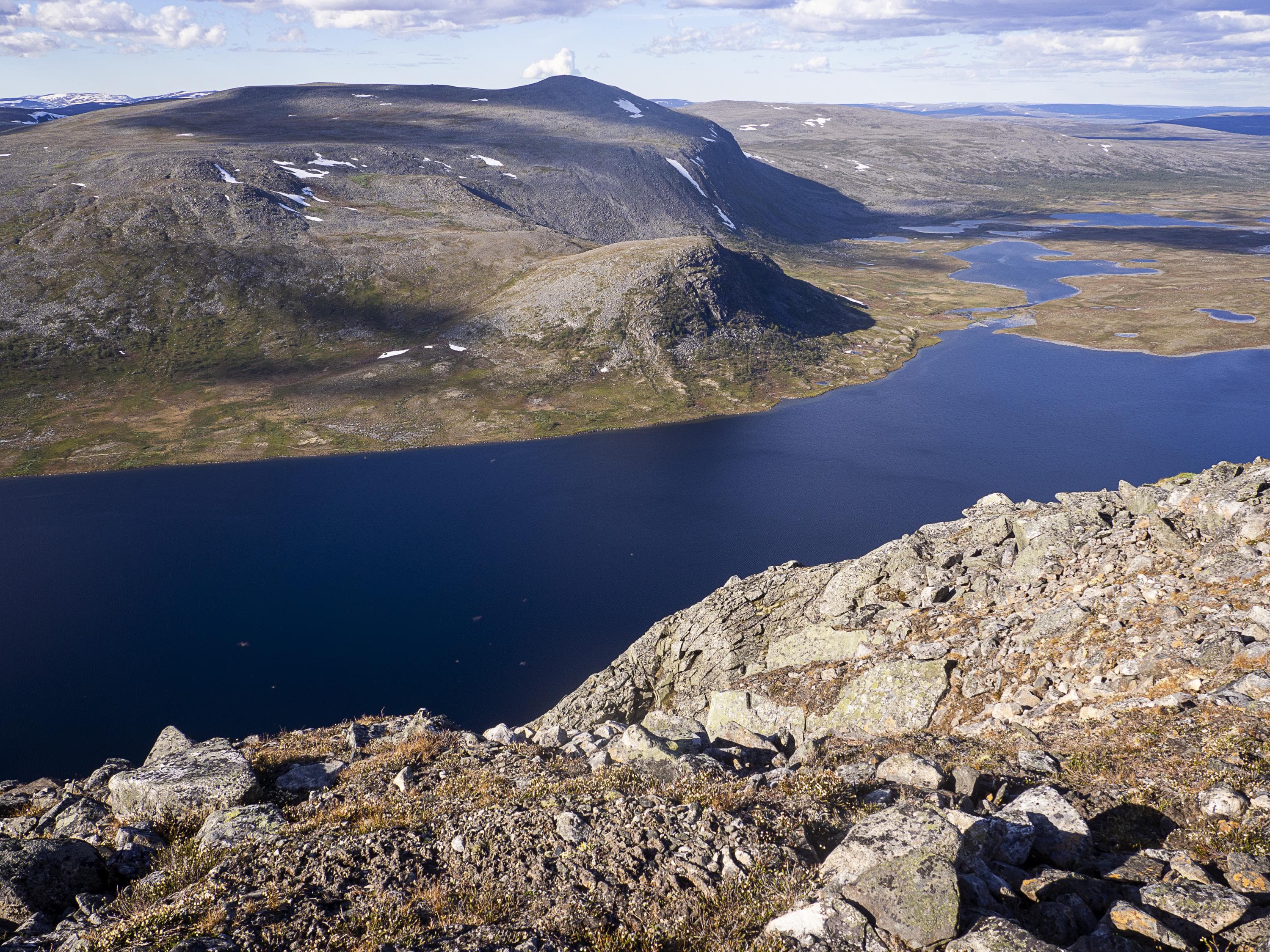 A fell rises behind the lake.