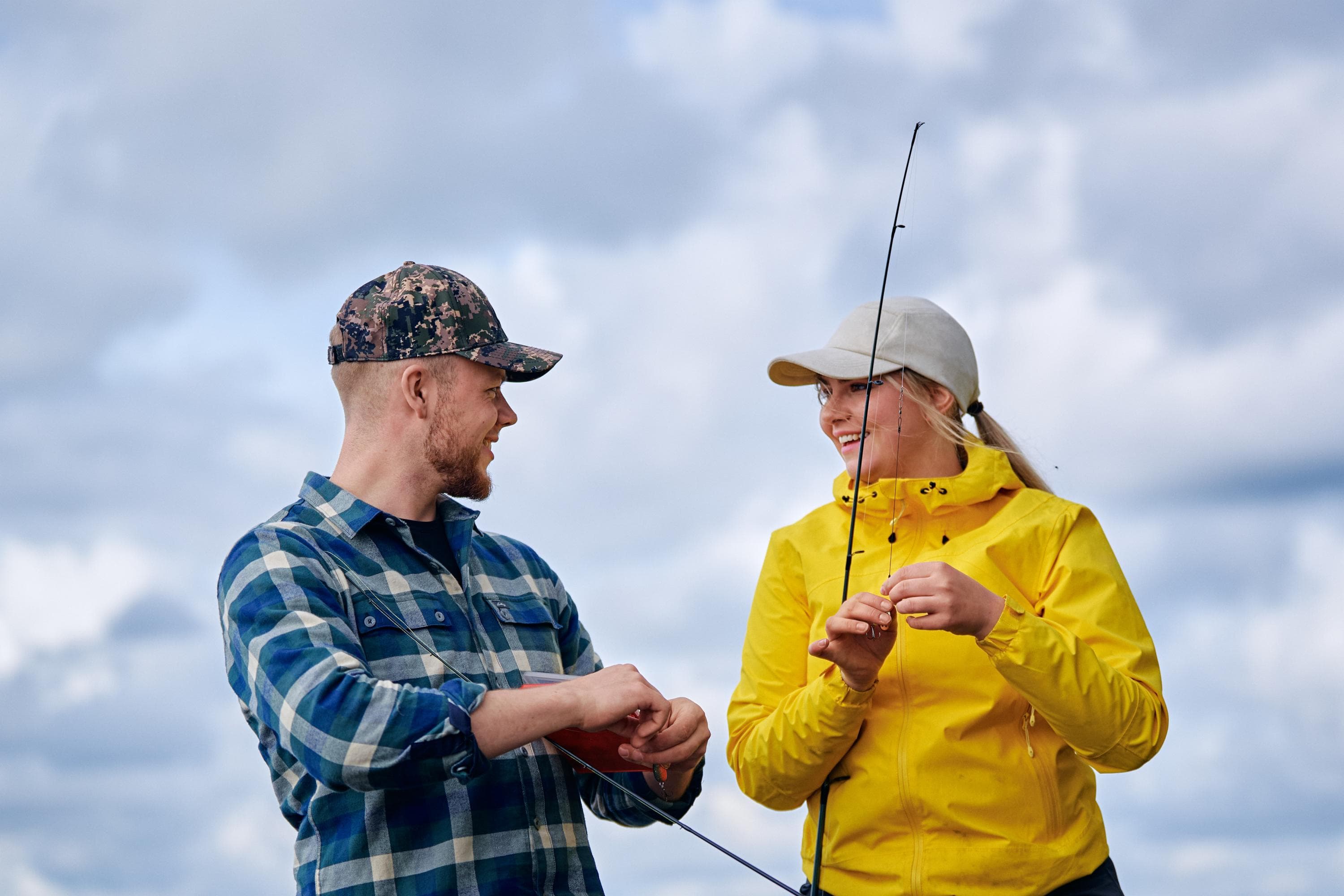 Image: Mikko Törmänen / Keksi Agency Two people look at each other and attach lures to their rods