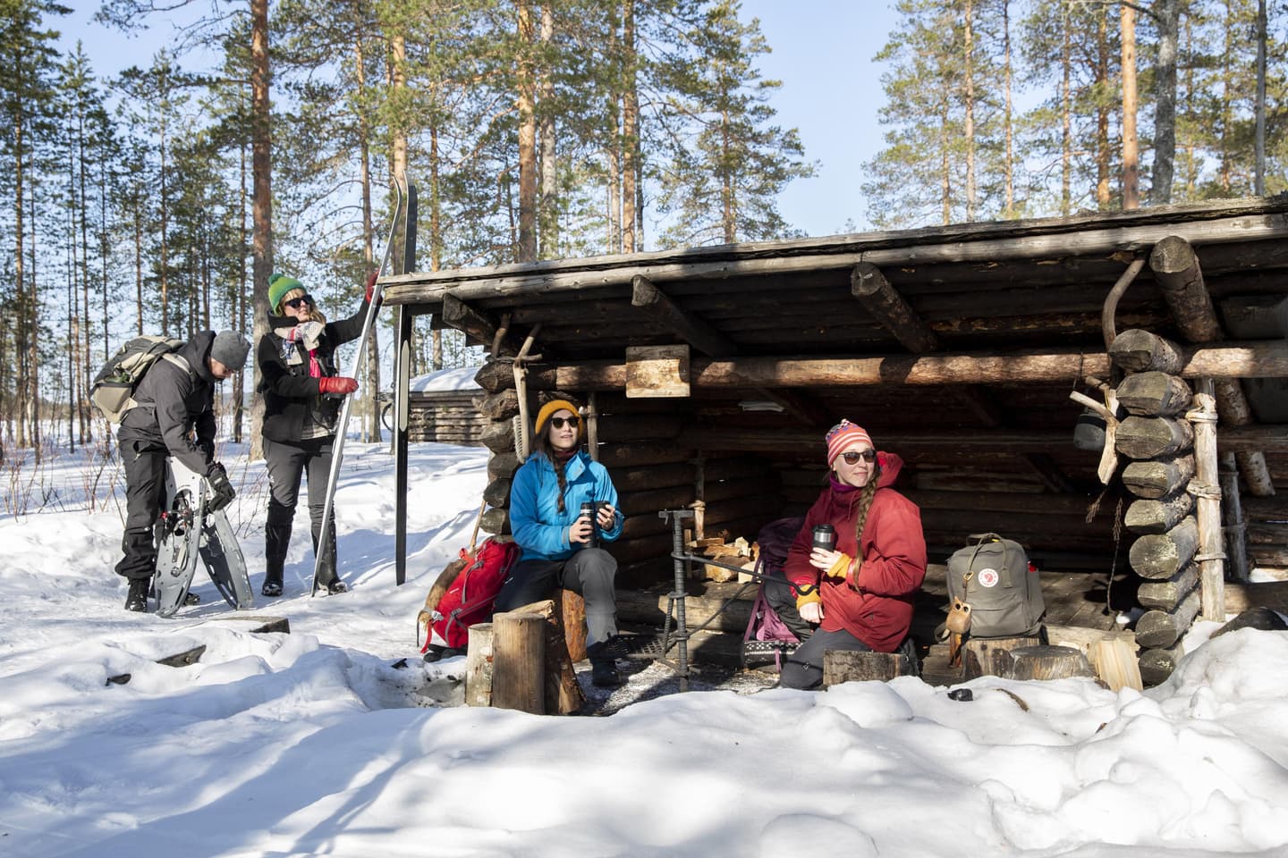 Image: Saara Lavi Hikers taking a break at a lean-to shelter during a wintry cross-country skiing trip.