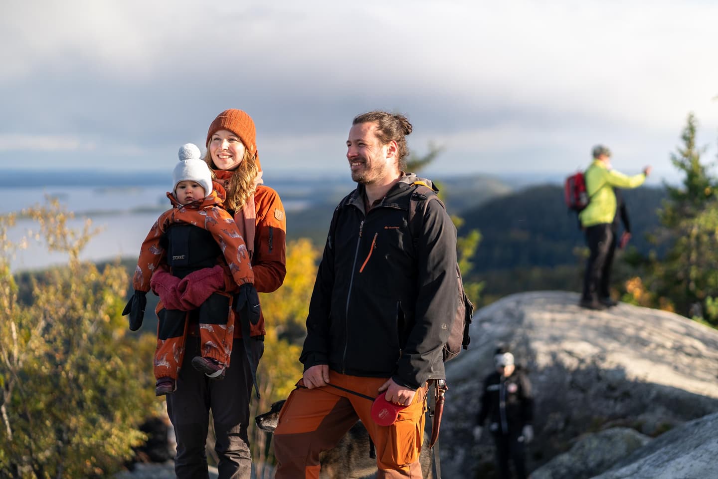 Image: Mitja Piipponen Hikers in the autumn sunshine on the summit of a high hill.